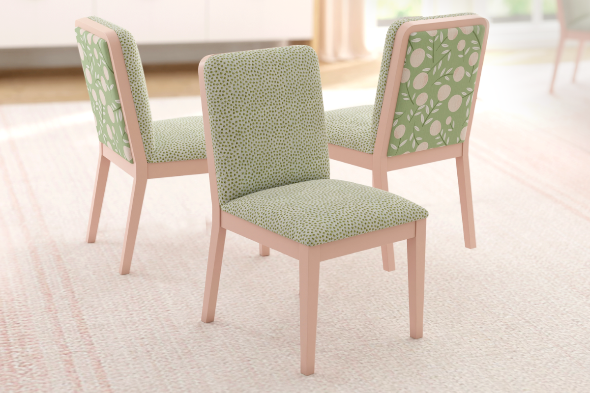 Three green patterned chairs with pink wooden frames on a light carpet.