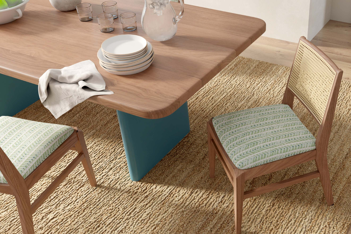 Solid wood Dining table with painted base and cane backed chairs with green geometric upholstered seat