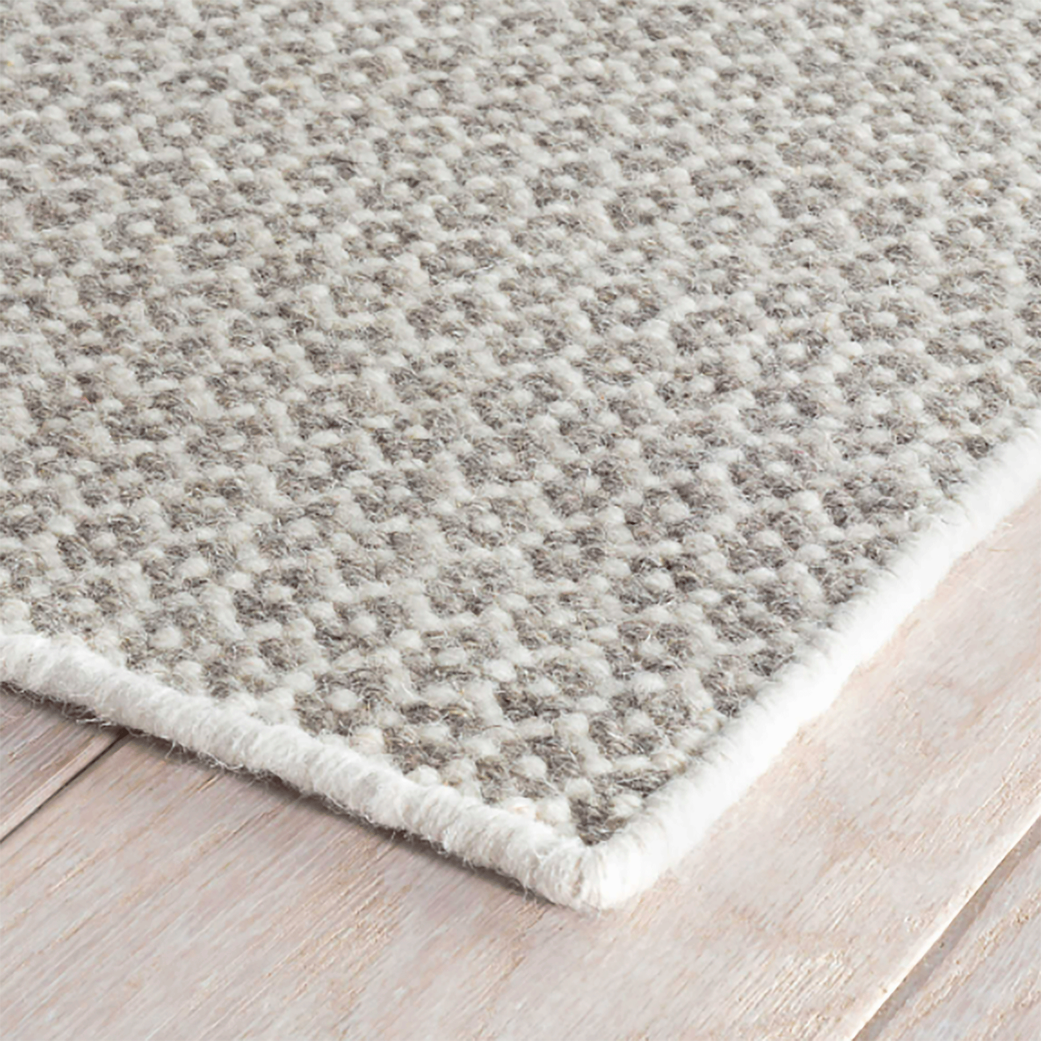 https://www.mainecottage.com/cdn/shop/products/honeycomb-ivory-grey-wool-woven-rug-corner_2048x.gif?v=1653423647